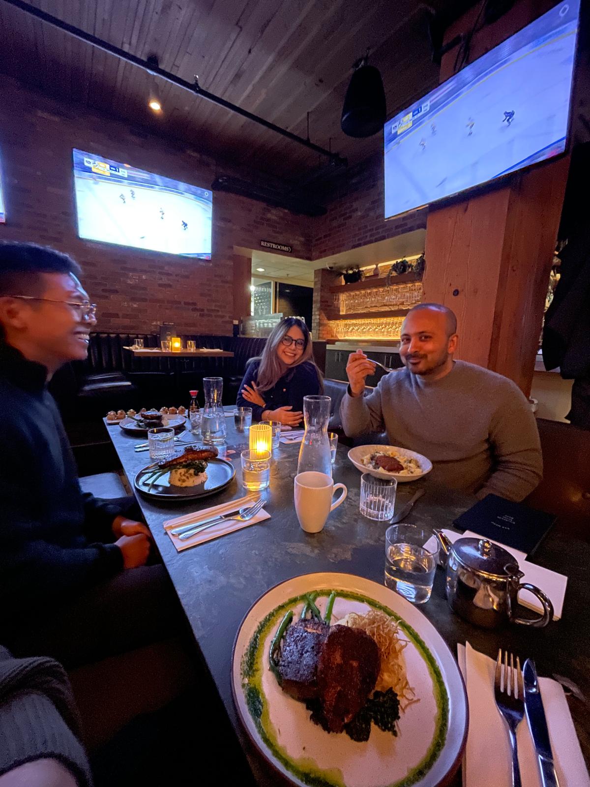 Founders laughing over dinner at a Founder Feast event