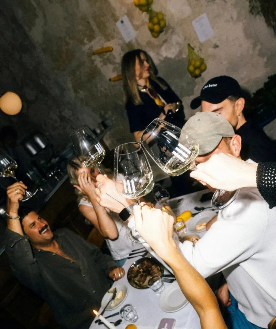 Founders raising wine glasses together at a Founder Feast dinner